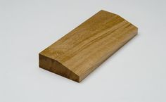 a piece of wood sitting on top of a white surface