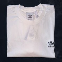 Brand New White Adidas T Shirt With Classic Adidas Logo On Front. Never Worn. Smoke Free Home Adidas Cotton T-shirt For Streetwear, White Sporty T-shirt With Branding, Basic Adidas T-shirt With Three Stripes, Adidas Basic T-shirt With Three Stripes, Adidas Cotton T-shirt With Crew Neck, White Adidas Sporty T-shirt, Adidas White Sporty T-shirt, White Crew Neck Graphic Tee, Adidas Graphic Tee Cotton T-shirt