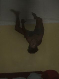 a man is upside down on the wall