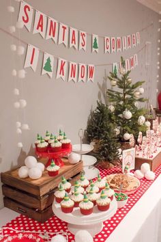 a table topped with cupcakes and christmas decorations