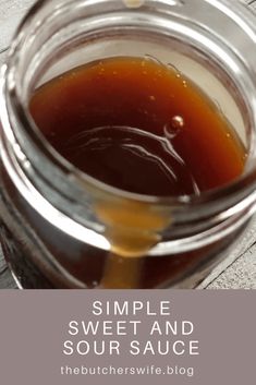 a jar filled with liquid sitting on top of a wooden table