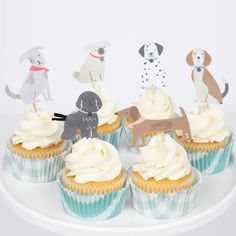 cupcakes with white frosting and dogs on top