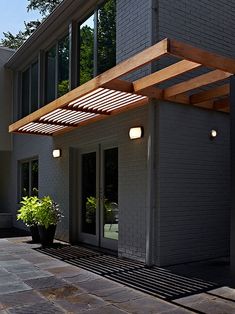 the outside of a modern house with an awning