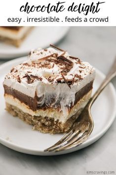 a white plate topped with a piece of cake covered in whipped cream and chocolate frosting