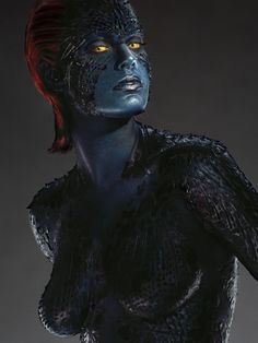 a woman with blue paint on her face and body is standing in front of a dark background