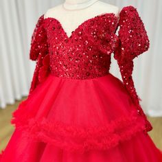 Dress your little princess in our elegant DreamyVow Red Girl Dress, featuring long sequined sleeves for a touch of sparkle. Perfect for birthdays and weddings, this gown is sure to make her feel like royalty. Made with high-quality materials, it offers both style and comfort. Get ready to make memories! Red Gown For Pageant During Prom Season, Princess Style Long Sleeve Ball Gown For Pageant, Red Sequined Ball Gown For Party, Holiday Pageant Tulle Ball Gown, Holiday Tulle Ball Gown For Pageant, Red Tulle Pageant Dress For Prom, Red Sequined Ball Gown For Wedding, Red Embellished Ball Gown For Party, Red Tulle Prom Pageant Dress