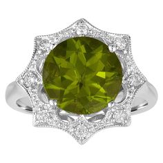 Beautiful Peridot & Diamond Ring. The ring is 18K White Gold The center stone is a Round Peridot 3.81 Carats There is 0.17 Carats in Diamonds H SI The top of the ring is 16.20mm in diameter. The ring is a size 6.5, sizable The ring weighs 6.2 grams 1960s Engagement Ring, Stars Jewelry, Diamond Gold Ring, Diamond Fashion Rings, White Diamond Ring, Contemporary Ring, Deco Engagement Ring, Peridot Ring, Diamond Star