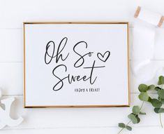 a sign that says oh so sweet hung on a wall next to some eucalyptus leaves