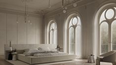 a large white bed sitting in a bedroom next to two windows with arched glass panes