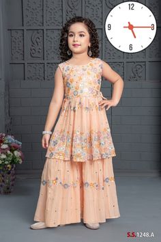 Embrace pure elegance with this stunning and beautiful Gharara set, showcasing a captivating peach hue. This two-piece set is meticulously crafted from premium-quality georgette fabric, ensuring a luxurious and comfortable fit. The anarkali top boasts an all-over floral thread embroidery, exuding a festive aura that is sure to dazzle any occasion. The Gharara pant is tailored in a voluminous and flowy cut, adorned with matching floral embroidery to complement the top. The top is provided with co Orange Georgette Sets For Reception, Festive Peach Dress With Floral Embroidery, Festive Peach Floral Embroidered Dress, Festive Floor-length Peach Sets, Festive Peach Floor-length Sets, Eid Peach Sharara With Chikankari Embroidery, Embroidered Orange Georgette Sharara, Orange Embroidered Georgette Sharara, Peach Georgette Sets For Eid