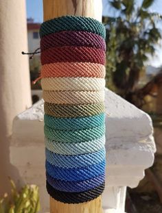 multicolored rope wrapped around a wooden pole