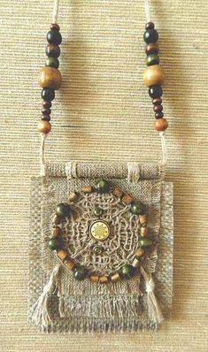 a beaded necklace with wooden beads and tassels hanging from it's side