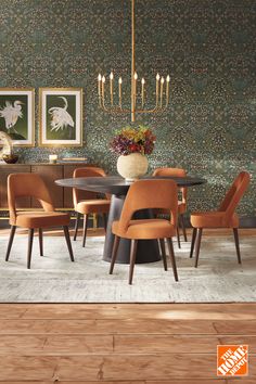 a dining room table with six chairs and a vase on top of it in front of a wallpapered background