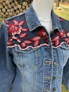 Beautiful women's size small petite denim jacket embellished with pink and maroon flowers embroidered on black tulle on front and back yokes. Jacket measures 19" across the chest when buttoned. This jacket would make such a beautiful, unique gift for the woman who loves one-of-a-kind items in her wardrobe!  Spot clean only!! Fitted Bohemian Outerwear With Floral Embroidery, Embellished Cotton Denim Jacket, Pink Embroidered Fitted Outerwear, Pink Fitted Embroidered Outerwear, Fitted Red Denim Jacket With Long Sleeves, Fitted Bohemian Denim Jacket For Fall, Bohemian Fitted Denim Jacket For Fall, Fitted Red Denim Jacket For Fall, Fitted Denim Jacket With Floral Embroidery For Summer