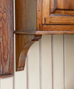 a close up of a wooden cabinet with wood trim