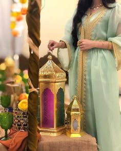 a woman standing next to a decorative lantern