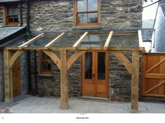 a stone building with wooden doors and windows