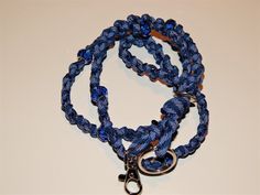 This lanyard has MANY uses! Stand out and make a statement at your work or your next meeting or conference with this one of a kind beaded name badge or ID neck lanyard! The Lanyard is woven 550 seven strand paracord and intertwined with various style beads. The paracord is durable, light weight, and soft and continues to get softer with wear. Extending from the base are two loops with a silver swivel spring clip to hold your name badge or belongings and a split key ring for additional items such Blue Lanyard With Key Leash For Personal Use, Handmade Blue Lanyards For Gifts, Handmade Blue Lanyards As Gifts, Handmade Blue Lanyard As Gift, Blue Lanyards With Key Leash As Gift, Blue Lanyard With Key Leash For Gift, Blue Lanyard With Key Leash As Gift, Lanyard Blue, Id Lanyard