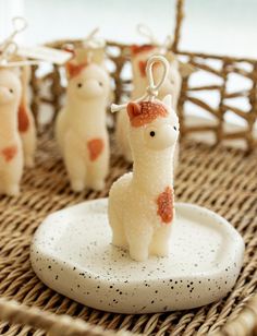 some little llamas are sitting on a plate