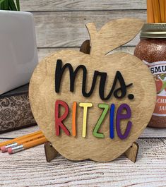 a wooden sign that says, mus ritze next to some school supplies