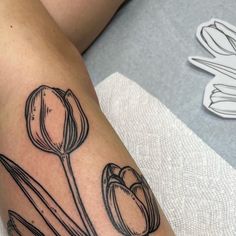 a woman's arm with flowers on it