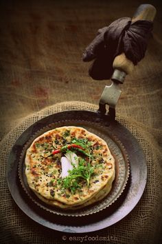 a pizza sitting on top of a pan covered in toppings next to a knife