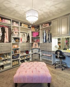 an organized closet with pink footstool, chandelier and shoe storage area