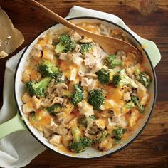 a casserole dish with chicken, broccoli and cheese in it on a wooden table