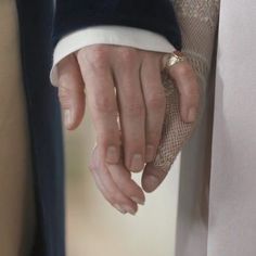 the bride and groom are holding hands with each other