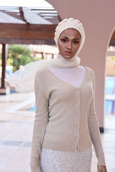 Complete your look with this stunning cream turban veil. Our Mystery in Cream Veil presents this magnificently embroidered turban to frame your face for a distinctive look. The one-piece turban veil is made especially for a simple yet classy fit that you can do yourself. The 58” long veil has a light cream shade to brighten up your dress.Whether it’s your wedding or engagement party, this turban veil will surprisingly shine up your special day and wow your guests.The turban's embroidery is based Luxury Wedding Turban For Women, White Headscarf For Wedding, Elegant White Headscarf For Wedding, Elegant White Wedding Headscarf, Fitted Headscarf For Wedding, Elegant Fitted White Turban, Elegant White Fitted Turban, Elegant White Hijab, Traditional White Headscarf