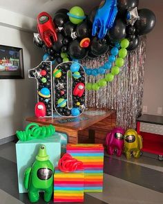 a room filled with balloons and decorations on the wall