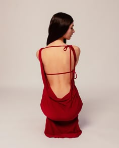 Introducing our Clara Dress, the perfect combination of elegance and fun! This backless gown features soft asymmetric draping that creates a figure-flattering silhouette, while delicate bows on the back add a playful touch. Crafted from soft fabric, this dress is the ultimate blend of comfort and style. Can be tied many ways and the strings can be cut to however short needed. Dark Red Backless Dress, Backless Casual Dress, Red Silk Backless Dress, Red Sleeveless Backless Dress With Tie Back, Chic Red Backless Maxi Dress, Red Backless Dress With Built-in Bra, Backless Gowns, Backless Gown, Classy Fits