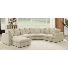 a large sectional couch in a living room with white carpeting and walls behind it