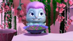 a cartoon character sitting in front of a bowl