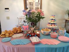 a table topped with lots of food and desserts