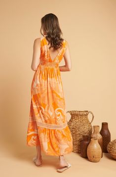 The Topaz Maxi Dress is a stunning, flowing gown that exudes warmth and beauty. Designed with a variety of different shades of orange, ranging from vibrant to more muted and subtle hues, this dress features a beautiful print of tropical plants and flowers, which adds a touch of exoticism and intrigue to the overall design. This is a unique garment. The imperfections in these fabrics are not considered defects, but characteristics that make them authentic. 100% Viscose. The model is wearing size Different Shades Of Orange, Tropical Plants And Flowers, Tropical Bohemian, Flowing Gown, Plants And Flowers, Dress Orange, Shades Of Orange, Tropical Plants, Topaz