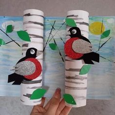 two paper roll crafts with birds on them