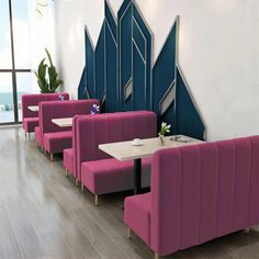 an empty restaurant with pink booths and blue dividers