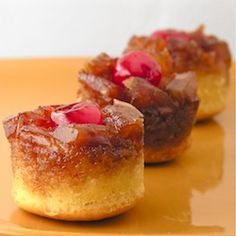 two small pastries with jelly on them are sitting on a yellow plate next to each other