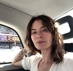 a woman sitting in the back seat of a car