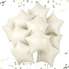 a bunch of white balloons with silver stars on them