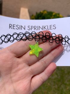 Each resin star pendant is handmade to order, therefore no two chokers are identical! However, I try to get as close as possible :) One size fits all black elastic tattoo choker necklace. Star width is approximately 20mm Made with resin and chunky iridescent neon lime green glitter ✨ UV blacklight reactive! Perfect for festivals, raves, parties, etc. Color may vary slightly 💚 Green Star-shaped Handmade Jewelry, Trendy Handmade Star-shaped Necklaces, Trendy Handmade Star-shaped Necklace, Trendy Handmade Star Necklaces, Handmade Trendy Star Necklaces, Handmade Green Star-shaped Jewelry, Adjustable Star Shaped Choker As A Gift, Adjustable Star Shaped Choker For Gift, Adjustable Star-shaped Choker For Gift