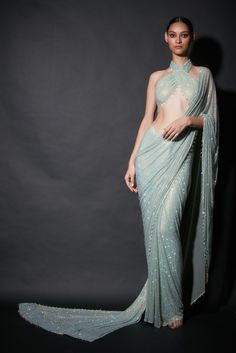 Editor's Note Featuring a pre-draped sari in refreshing shade of mint green paired with halter blouse Fabric: Net Color: Mint green Neckline: Halter Sleeve type: Sleeveless Component: Sari and blouse Occasion: Cocktail and reception Care: Dry Clean Only About the Designer Itrh makes a high-end luxury Indian ethnic wear made using exquisite and endangered age-old crafts such as kalamkari, madhubani, chikankari, zardozi, and gota weaving. The focus of the house is to cherish the beauty of handcraf Farewell Saree, Saree Backless, Extra Outfits, Eternal Beauty, Halter Blouse, Simple Sarees, Saree Designs Party Wear, Indian Fashion Saree, Drape Saree