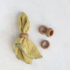 a pair of baby shoes sitting next to a yellow scarf