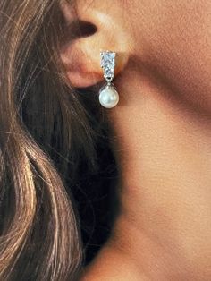 The Gorgeous DARA Earrings with Swarovski & Cubic Zirconia Crystals and Pearls are Absolutely Beautiful. They are long and beautiful to give you that elegant look. They can be styled with most of our wedding headpieces and Bridal Tiaras and Crowns for a majestic and elegant look. Handcrafted Highest Quality Swarovski / Cubic Zirconia Platinum plated Guards against scratches and tarnish. approximate size 1.25" length 0.5" width Nickel free Free Shipping in USA Elegant Crystal Pearl Earrings With Sparkling Stones, Elegant Diamond White Dangle Bridal Earrings, Elegant Bridal Earrings With Cubic Zirconia, Elegant Cubic Zirconia Bridal Earrings, Elegant Pearl Earrings With Sparkling Stones, Elegant Crystal Bridal Earrings For Pierced Ears, Elegant Diamond White Pearl Earrings For Wedding, Elegant Bridal Crystal Earrings For Pierced Ears, Elegant Cubic Zirconia Dangle Bridal Earrings