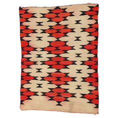 an old navajo rug with red and black designs on it's edges, in the middle