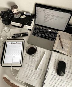 an open laptop computer sitting on top of a desk next to a cup of coffee