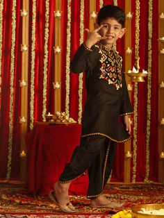 VASTRAMAY Boys' Black Navratri Special Embroidered Dhoti Kurta Set A perfect attire for your little one this Navratri season! This black dhoti kurta set features intricate embroidery, offering a traditional yet stylish look. Made with high-quality fabric, it ensures comfort and elegance. Features: Intricate embroidery Comfortable fabric Traditional design Specifications: Color: Black Size: Boys' Occasion: Navratri Special Material & Care: Material: Cotton Care: Hand wash or machine wash with gen Dabka Straight Kurta Choli For Navratri, Navratri Choli With Dabka Details, Black Sharara For Festive Navratri, Black Sharara For Festive Navratri Occasions, Festive Black Choli For Eid, Black Kurta For Navratri Traditional Ceremonies, Traditional Drape Wear With Dabka For Puja, Navratri Festive Embroidered Churidar, Black Sets With Dabka Work For Celebration