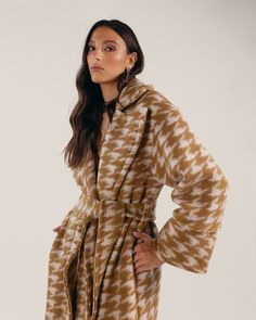 Introducing our Cassie Coat, a cozy cocoon crafted to keep you warm and stylish all winter long. Made from a luxurious, sustainable wool blend in an earthy checked pattern with hints of green or orange, this cold-weather essential offers unparalleled comfort, boasting thoughtful details like a detachable belt, convenient(ly) deep pockets, and full lining. Wrap up and head out in your new favorite winter coat.This sustainable coat is tailor made and on demand and takes us 9 hours to make it. Plea Brown Houndstooth Winter Outerwear, Brown Houndstooth Outerwear For Winter, Brown Houndstooth Outerwear For Fall, Winter Wool Houndstooth Outerwear, Wool Houndstooth Outerwear For Winter, Wool Outerwear For Winter Loungewear, Wool Outerwear For Winter, Coats For Winter, Smooth Jazz Music