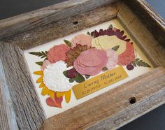 a wooden frame with some flowers on it